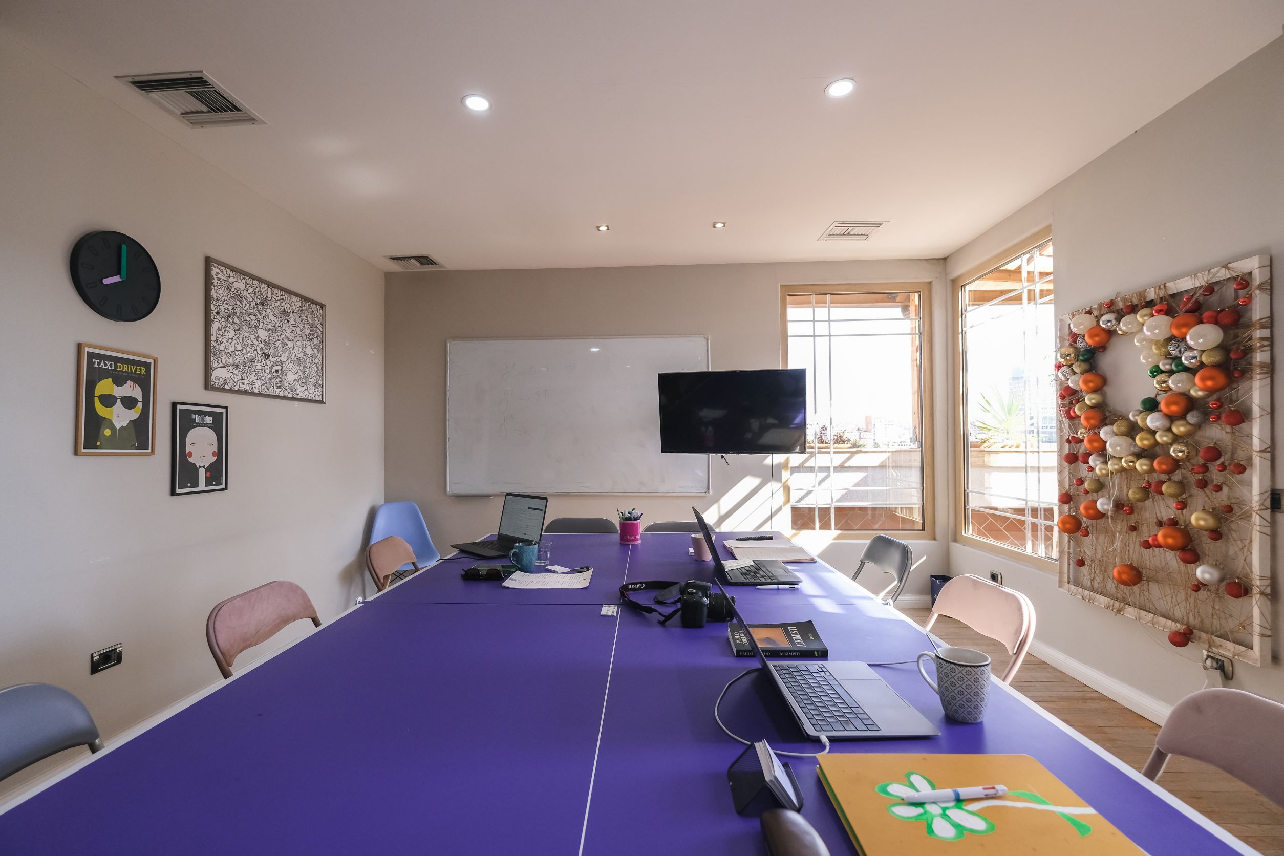 The meeting room at Innospace Tirana, with a long table, a whiteboard and a wall-mounted screen